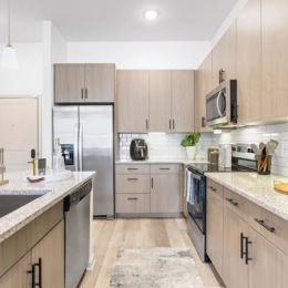 kitchen with ample counter-space, modern appliances and bright lighting