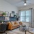 a living room with a desk and a chair