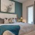 a bedroom with a bed and a lamp