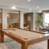 game room on wood-style flooring with a pool table